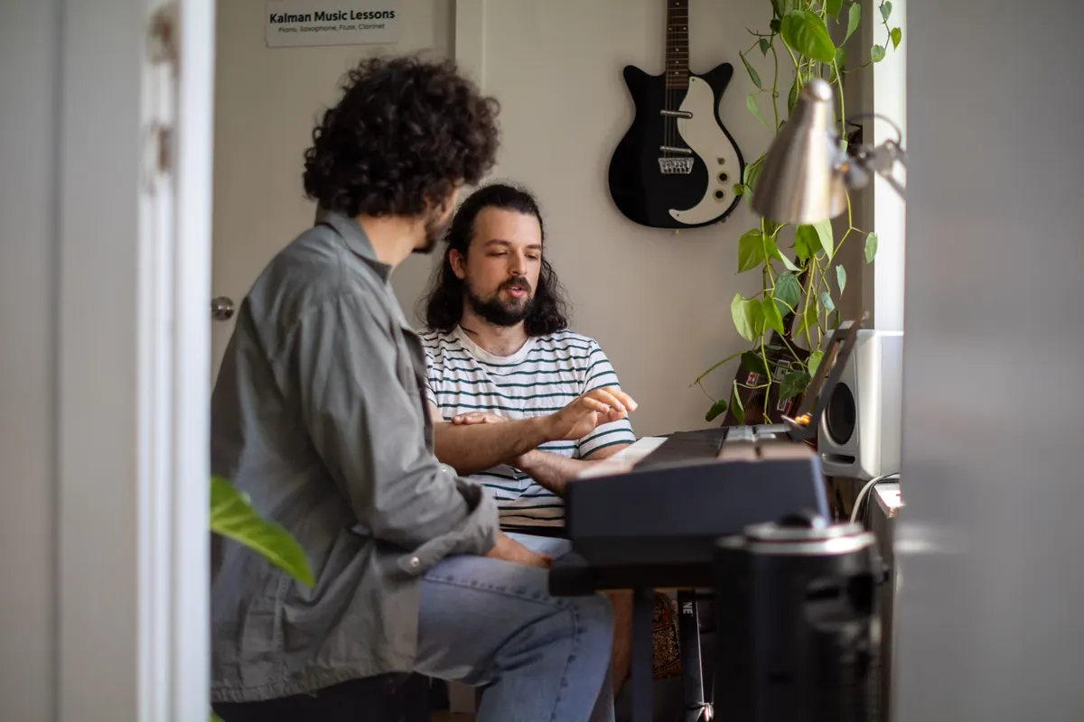 A teacher and student at the keyboard in a Kalman Music Lessons studio