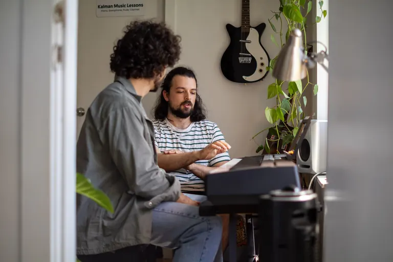 A teacher and student at the keyboard in a Kalman Music Lessons studio